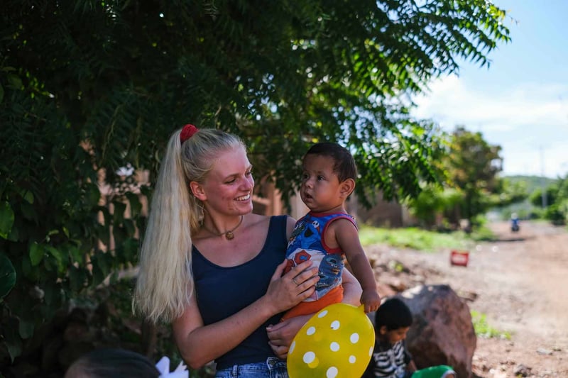 YWAM missionary woman holding a child while doing ministry at a YWAM Mazatlan medical brigade