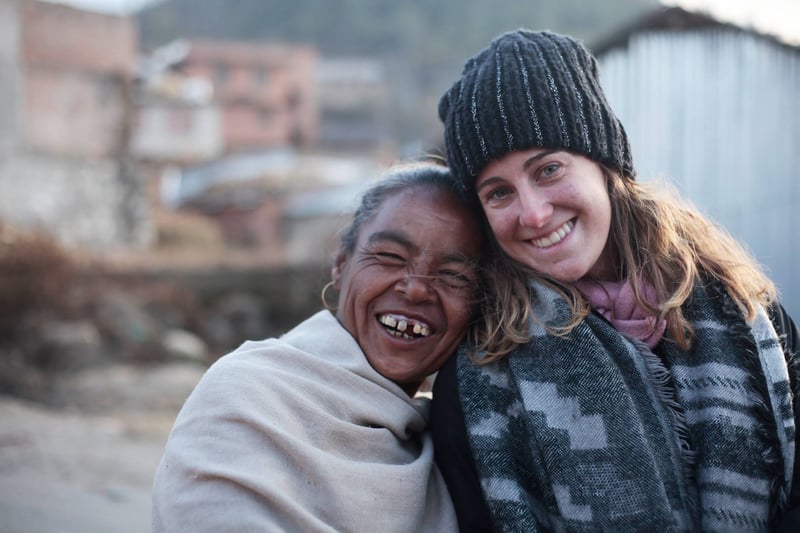 Young missionary woman and an elderly Nepali woman posing for a photo while on outreach in Nepal