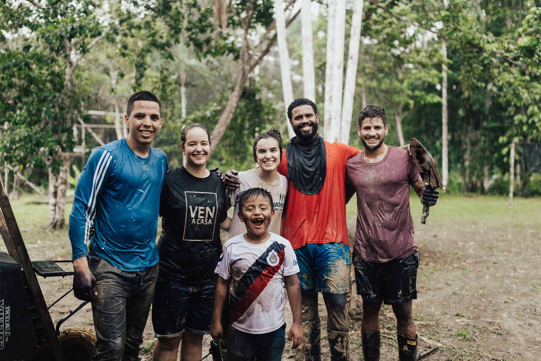 YWAM missionaries smiling in the rain while on outreach in the Amazon jungle